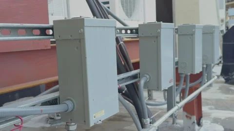 Row of Gray Electrical Disconnect Switches  Enclosures Mounted on Metal Unistrut 库存影片 335186267