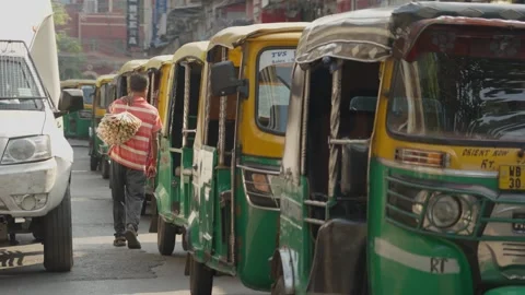Row Of Green And Yellow Auto Rickshaws On Busy Indian Summer Street Stock Footage 333427348