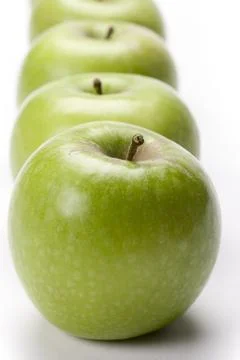 Row of green apples Stock Photos