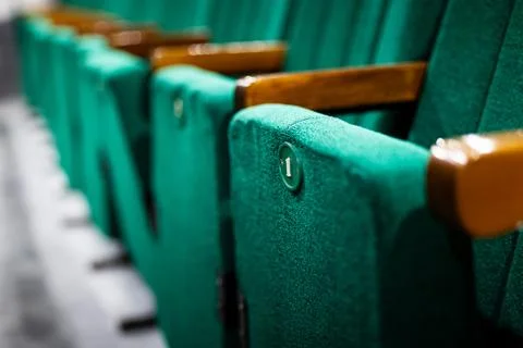 A row of green comfortable chairs at an opera theater  Stock Photos