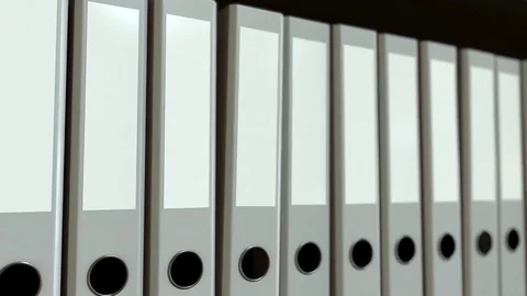 Row of grey office binders. Loopable motion background Stock Footage