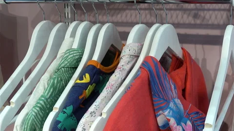 A row of hangers with colored clothes Stock Footage 125663707