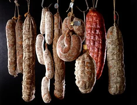 Row of hanging salamis Stock Photos