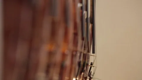 Row of hanging violins gently sway Stock Footage 74309652