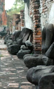 A row of headless Buddha statues. Stock Photos