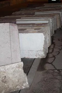 Row of heavy concrete security barriers on a city street at night 스톡 사진