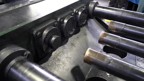 Row of heavy steel extrusion rams and cylinders lined up inside a hydraulic 動画素材 347124010