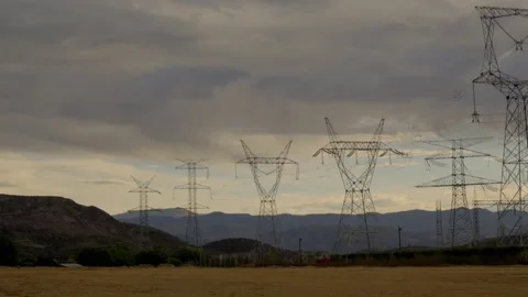 Row of high voltage electricity pylons under a stormy sky Stock Footage 340148736
