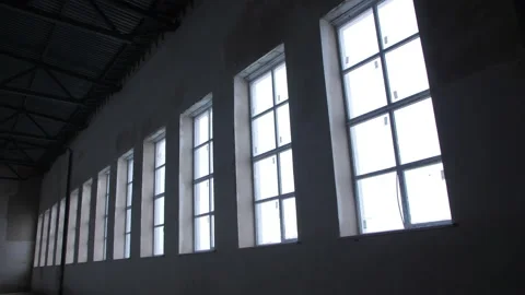 Row of high windows on wall of unfinished workshop building Vídeos de archivo 223392553