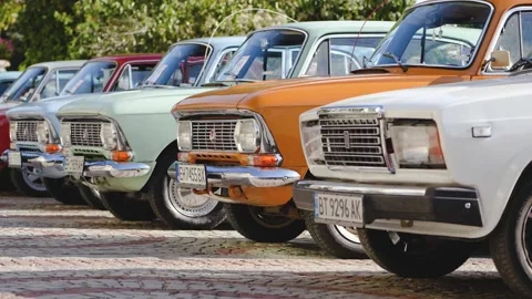 Row of iconic Soviet cars including Lada and Moskvich at a vintage parade Stock Footage 318082527