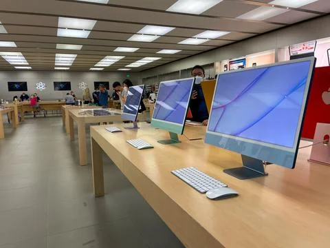 A row of iMac Computers at an Apple store. Stock Photos