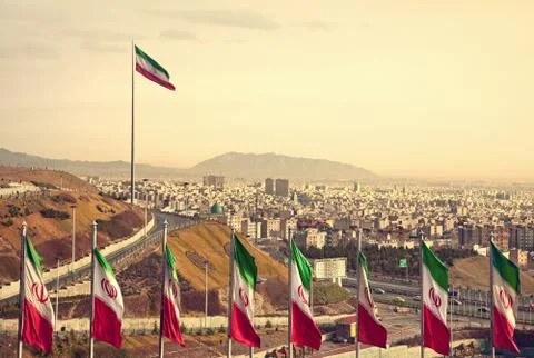 Row of Iran Flags in Front of Tehran Skyline Stock Photos