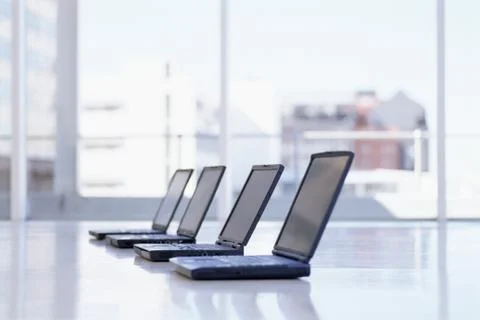 Row of laptops on a desk Stockfoto's