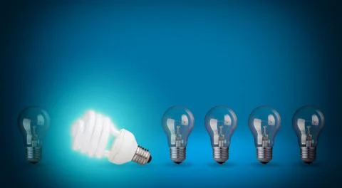 Row of light bulbs and energy save bulb. idea concept on blue background. Stock Photos