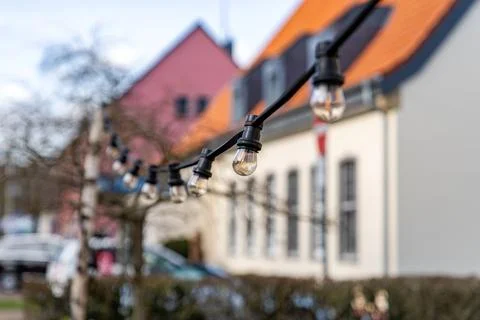 A row of lights hanging from a tree Stock Photos