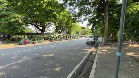 Row of local pedicabs waiting for passengers near Intramuros Manila 4K Stock Footage 337458692