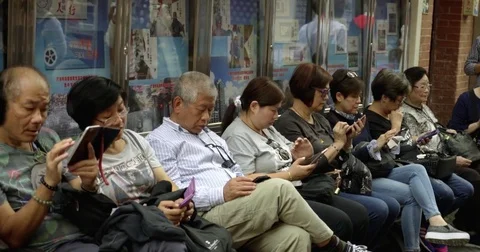 A Row of Locals using their Phones in a market in Shanghai, China 4K Stock Footage