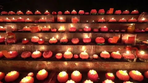 Row of lotus candle burn at table Stock Footage 179364064