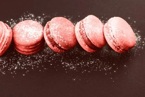 Row of macaroons on black Stock Photos