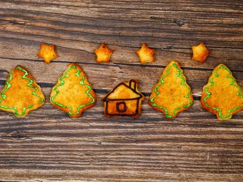 Row made from cookies in shape of house, Christmas trees and stars Stock Photos