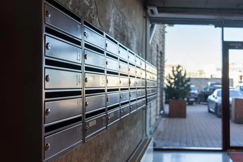 Row of mailboxes inside modern residential apartment building entrance Фото