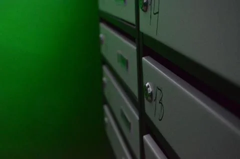 A row of mailboxes with numbers on them. Stock Photos
