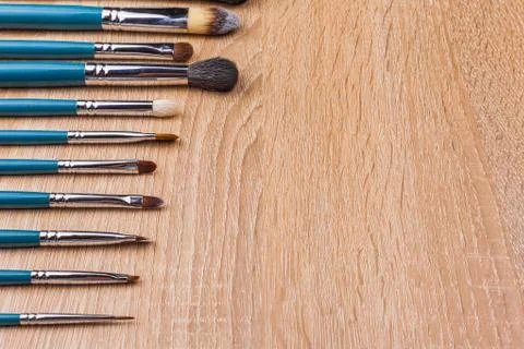 Row of makeup brushes in blue coating Stock Photos