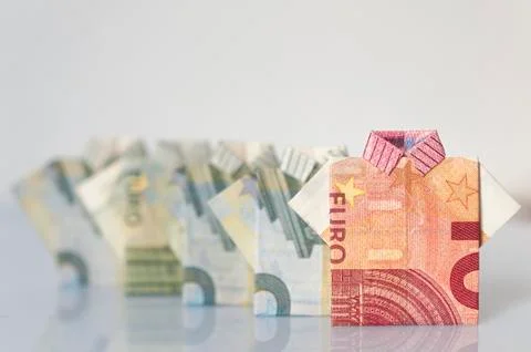 A row of men made with five and ten euro bills folded like a t-shirt Stock Photos