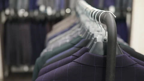 Row of men suit jackets on hangers. Collection of new beautiful clothes hanging Stock-Footage 91217469
