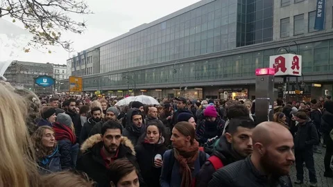 Row of men walk through crowd at “me too” demonstration, Hermannplatz, Berlin Vídeos de archivo 81856193