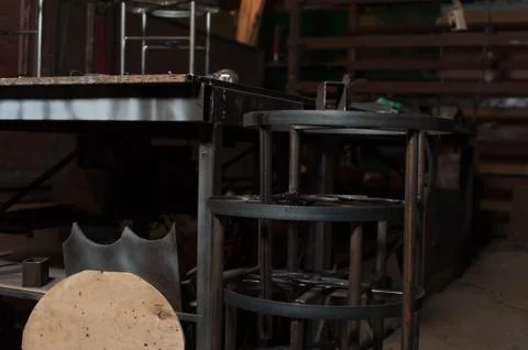 Row of metal chairs in blacksmith workshop Stock Photos
