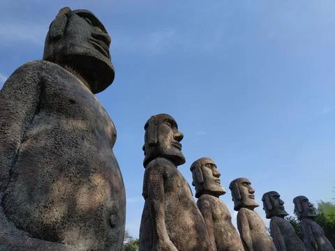 Row of Moai Statues in a Park Setting Stock Photos