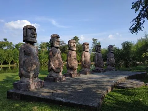 Row of Moai Statues in a Park Setting Stock Photos