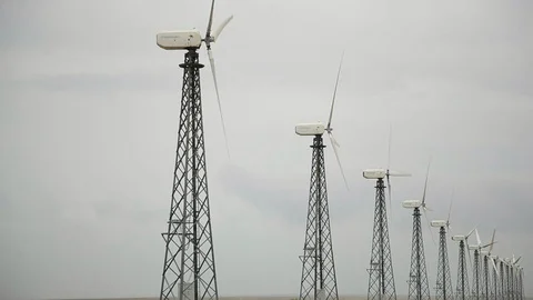 Row of modern wind generators, cloudy grey sky bg 動画素材 97101271