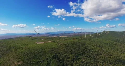 Row of modern wind turbines generating clean and renewable energy . 4k Stock Footage 97929037