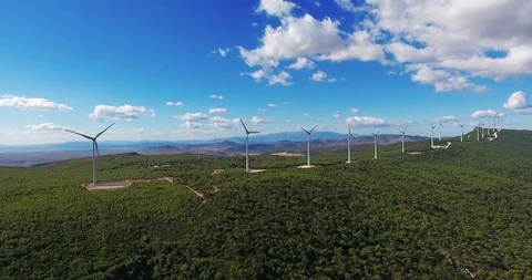 Row of modern wind turbines generating clean and renewable energy . 4k Stock Footage 97929526