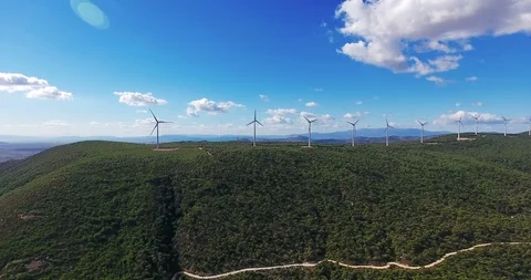 Row of modern wind turbines generating clean and renewable energy . 4k Stock Footage 97929772