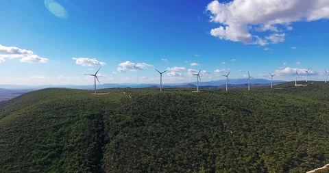 Row of modern wind turbines generating clean and renewable energy . 4k Stock Footage 97929800