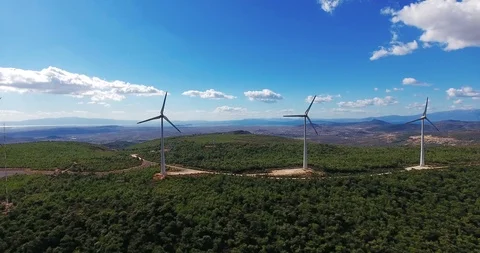 Row of modern wind turbines generating clean and renewable energy . 4k Stock Footage 97929964