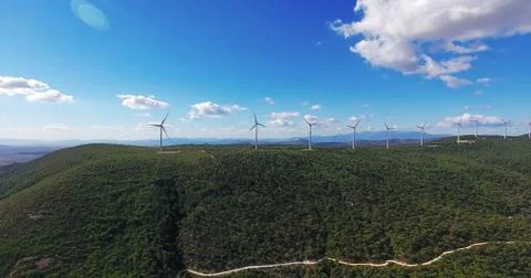 Row of modern wind turbines generating clean and renewable energy in the coun Stock Photos