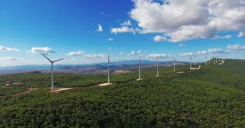 Row of modern wind turbines generating clean and renewable energy in the coun Stock Photos