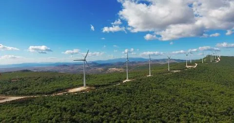 Row of modern wind turbines generating clean and renewable energy in the coun Stock Photos