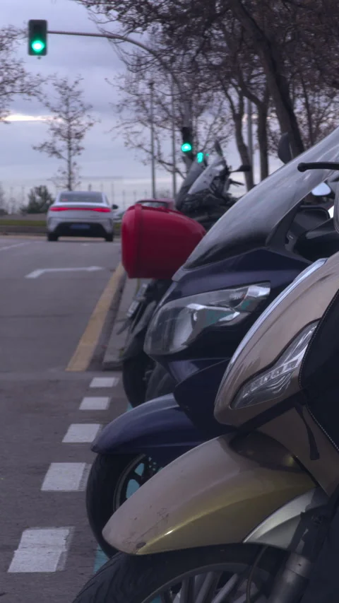 A row of motorcycles are parked on the side of the road Stock-Footage 326956257