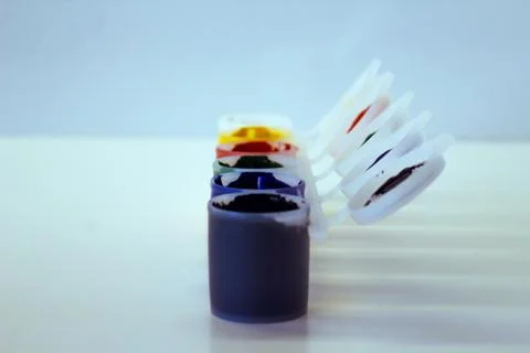 Row of multi-colored gouache with open lids,Image with selective focus. Stock Photos