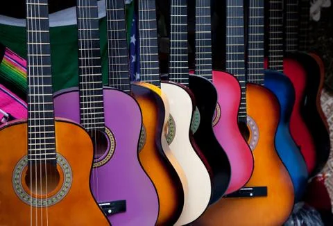 Row of multi-colored mexican guitars Stock Photos