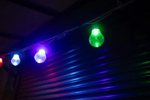 A row of multicolored glowing bulbs Stock-Fotos