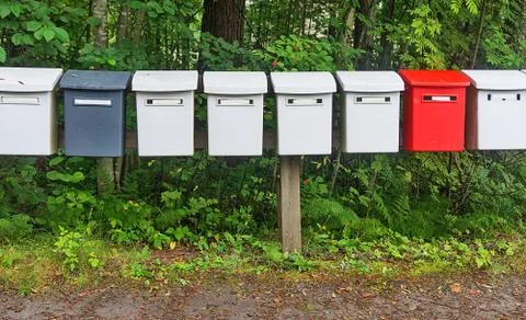 Row multicolored postboxes in the park Stock Photos
