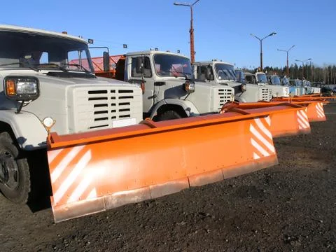 Row of new snow plows Stock Photos