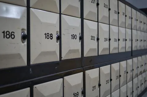 Row of numbered lockers with combination dial lock. Stock Photos