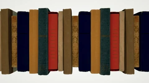 A row of old books in multi-colored covers move from right to left on a white Stock Footage 155179224